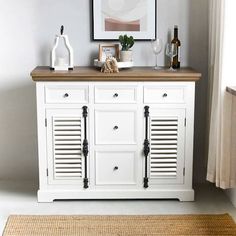 a white cabinet with doors and drawers in a room