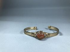 The fire in this opal is absolutely stunning!  It is set in a 14k gf cuff that easily bends to fit most wrist sizes. Adjustable Gold Jewelry With Ethiopian Opal, Adjustable Gold Ethiopian Opal Jewelry, Gold Spiritual Wire Wrapped Cuff Bracelet, Handmade Gold Carnelian Bracelets, Gold Carnelian Bracelet, Mexican Fire Opal, Copper Cuff Bracelet, Copper Cuff, Stone Wrapping