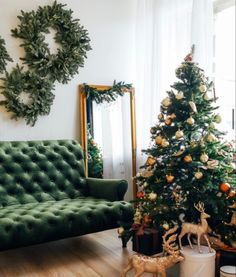 a living room decorated for christmas with green velvet sofa