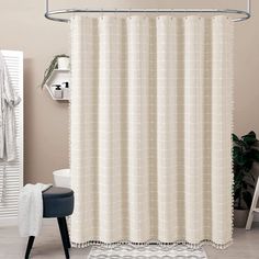 a bathroom with a shower curtain and rug