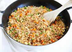 a pan filled with rice and vegetables on top of a table