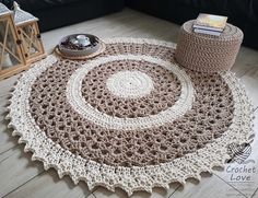 a crocheted rug is on the floor in front of a black couch