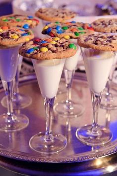 desserts are arranged in wine glasses on a table