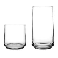 two empty glasses sitting next to each other on a white surface with no one in it