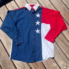 Festive western panhandle slim shirt. Perfect for 4th of July or for showing patriotism all year round. Has a small pick on the front, as shown, and some wear on the right cuff. Fits like a large. Please refer to measurements.  23" pit to pit, 30" nape to hem, 22" shoulder to shoulder, 23" shoulder to cuff. b09 American Style Cotton Shirt With American Flag, Americana Cotton Shirt For Memorial Day, American Flag Print Shirt For Memorial Day, Americana Shirt With American Flag Print For Memorial Day, Americana Style Shirt With Flag Print For Independence Day, Americana Style Cotton Shirt With American Flag, Americana Long Sleeve Tops For 4th Of July, Memorial Day Americana Cotton Shirt, Americana Shirt With American Flag For Independence Day