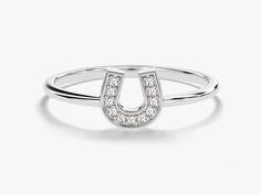 The Diamond Horseshoe Ring is a stunning and symbolic piece that elegantly merges a sense of timeless charm with the allure of diamonds. Expertly crafted, this ring showcases a horseshoe motif adorned with shimmering diamonds, invoking luck, protection, and beauty themes. DETAILS:--Size Range: 2 US - 11 US--Weight (in 14k Gold): ~ 1.21 grams for Size 6.5 (Depends on the size)--Gold Kt Options: 14k and 18k--Color Options: Yellow Gold, Rose Gold and White Gold--Gemstone: Diamond--Diamond Cut: Roun Elegant Yellow Gold Horseshoe Rings, Elegant Horseshoe Rings For Gifts, Classic Horseshoe Shaped Anniversary Rings, Horseshoe Diamond Ring For Anniversary, Diamond Horseshoe Ring For Anniversary, White Gold Horseshoe Jewelry For Anniversary, Formal Horseshoe Jewelry With Diamond Accents, Luxury Horseshoe-shaped Formal Jewelry, Luxury Horseshoe Jewelry For Formal Occasions