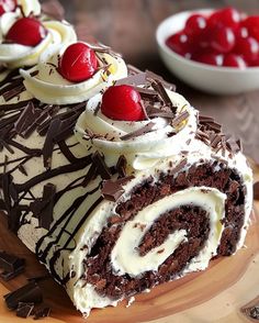 a chocolate cake with white frosting and cherries on top