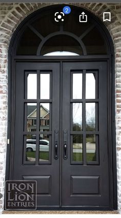 the front door is black and has two sidelights