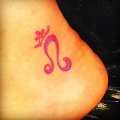 a tattoo on the side of a woman's foot with a pink and purple design