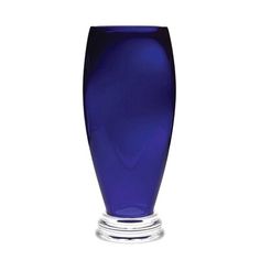 a blue glass vase sitting on top of a table