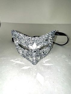 Mask with comfort plus wear. Handmade, for personal use or home decoration. Available in different colors: gold, red, blue, purple, black, and more! Hand-held stick option available. Silver Eye Mask For Theater, Masquerade Mask Silver, Elegant Silver Eye Mask, Silver Fantasy Costume Mask, Masquerade Mask Blue Silver, Mask Masquerade, Costume Mask, Masquerade Mask, Elastic Band