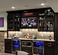 a home bar with built in wine coolers