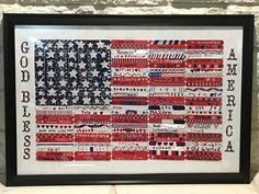 an american flag made out of different types of sewing threads is displayed in a black frame