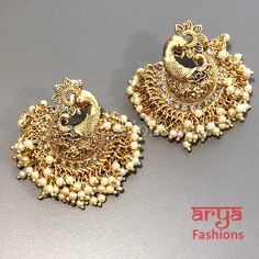 Saba Amrapali Inspired Golden Polki Chandbali Earrings Premium Quality Polki Chandbali Earrings Length: Approx. 2" Light-weight Push-Back closure Gold Finish on high-quality brass as the base metal, Kundan stones and Pearls Suitable for any traditional for contemporary attire and occasion In-stock & ready-to-ship **Color may vary slightly due to photography and lighting. Gold Chandbalis With Peacock Design For Festivals, Elegant Latkans Earrings For Puja, Elegant Heavy Danglers For Puja, Gold Earrings With Peacock Design For Puja, Gold Bollywood Earrings With Peacock Design, Bollywood Style Peacock Design Chandbali Jewelry, Elegant Peacock Design Chandbalis For Festivals, White Chandbali Earrings For Navratri, Peacock Design Earrings For Festivals And Celebrations