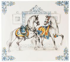 two white horses with blue and yellow decorations on their backs, standing next to each other