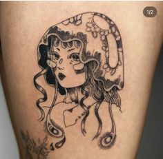 a woman's thigh with a tattoo design on it