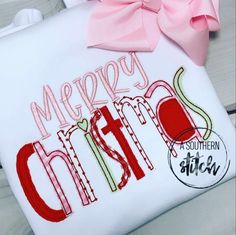 a white t - shirt with the words merry christmas on it and a pink bow