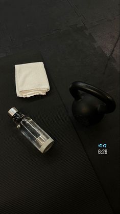 a black mat with a lighter, napkin and bottle on it