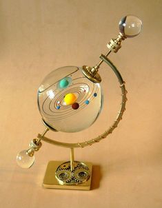 a glass and metal model of the solar system