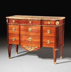 an antique dresser with marble top and gold trimmings on the front, side view