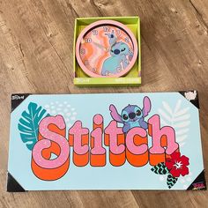 a clock with stitch on it sitting next to a box that has the word stitch in front of it