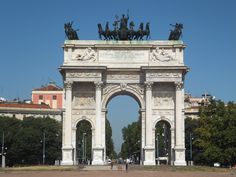 a large white arch with statues on top