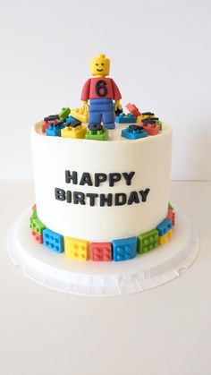 a birthday cake decorated with legos and the words happy birthday