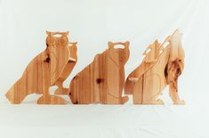 three wooden owls sitting on top of each other