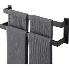 two gray towels are hanging on a black towel rack and one is folded over the other