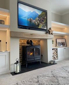 a flat screen tv mounted on the wall above a fireplace