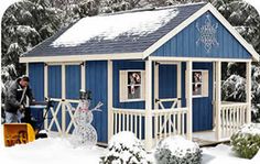 a small blue and white building with snow on the ground