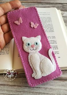 a bookmark with a cat and butterflies on it