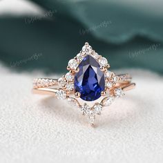 an engagement ring with a large purple stone surrounded by small white and rose gold diamonds