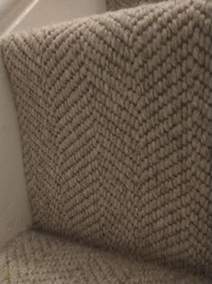 the corner of a chair with a blanket on it