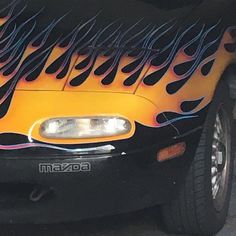 a car with flames painted on it's hood