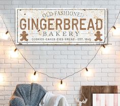 an old fashioned gingerbread bakery sign on a brick wall above a chair and table