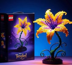 a yellow flower is in front of a purple box with the word tangled on it