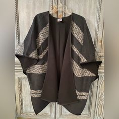 Ladies Black Poncho With Black, Grey, And White Patterned Intermittent Horizontal Stripes. This Poncho Is 33” Long And 45” From Side To Side. There Are Black Frog Closures On Each Side To Keep The Poncho Somewhat Closed. This Poncho Has Never Been Worn/ Used. Chic Black Oversized Cape, Chic Oversized Black Cape, Chic Black Cape For Fall, Chic Black Fall Cape, Black Shawl Cape For Fall, Black Oversized Batwing Sleeve Outerwear, Oversized Black Outerwear With Batwing Sleeve, Black Batwing Sleeve Outerwear For Layering, Black Outerwear With Batwing Sleeves For Layering