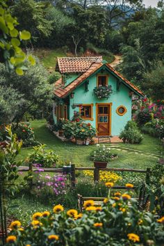 a small blue house surrounded by flowers and greenery