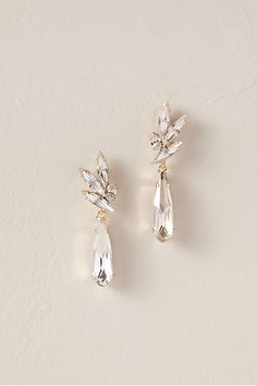 two pairs of earrings with crystal stones on the front and back of each earring