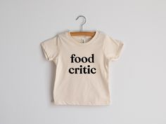 Food Critic Organic Kids T-shirt Modern Baby and Kids Graphic Tee natural Organic Cotton Cream Tee funny Shirt for Picky Eaters - Etsy Toddler T Shirt Ideas, Groovy Typeface, Toddler Tshirt Ideas, Mama Shirt Ideas, Kids Tshirt Ideas, Neutral Kids Clothes, Funny Baby Shirts, Toddler Graphic Tee, Funny Toddler Shirt