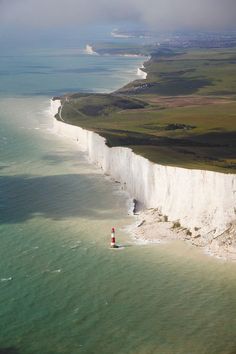 an aerial view of the white cliffs and lighthouses at seven sisters beach in england