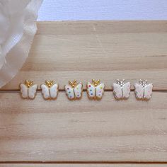 four little butterflies sitting on top of a wooden table