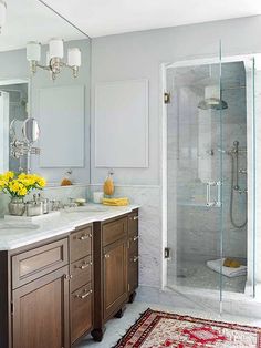 a bathroom with two sinks, a shower and a rug on the floor in front of it