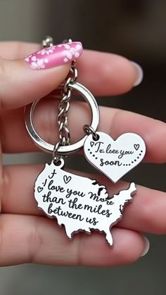 a person holding a keychain that says i love you more than the united states