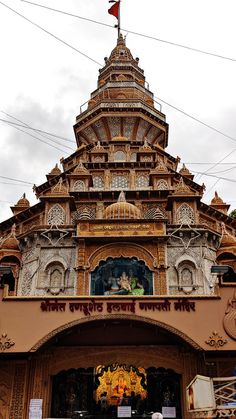 an ornate building with a flag on top