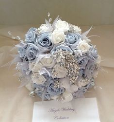 a bridal bouquet with blue roses and pearls