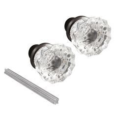 two clear glass knobs with black metal handles