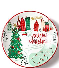 a christmas plate with an image of a town and a tree on the front, along with words merry christmas