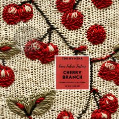 a red and white crocheted blanket with flowers on it, next to a sign that says cherry branch